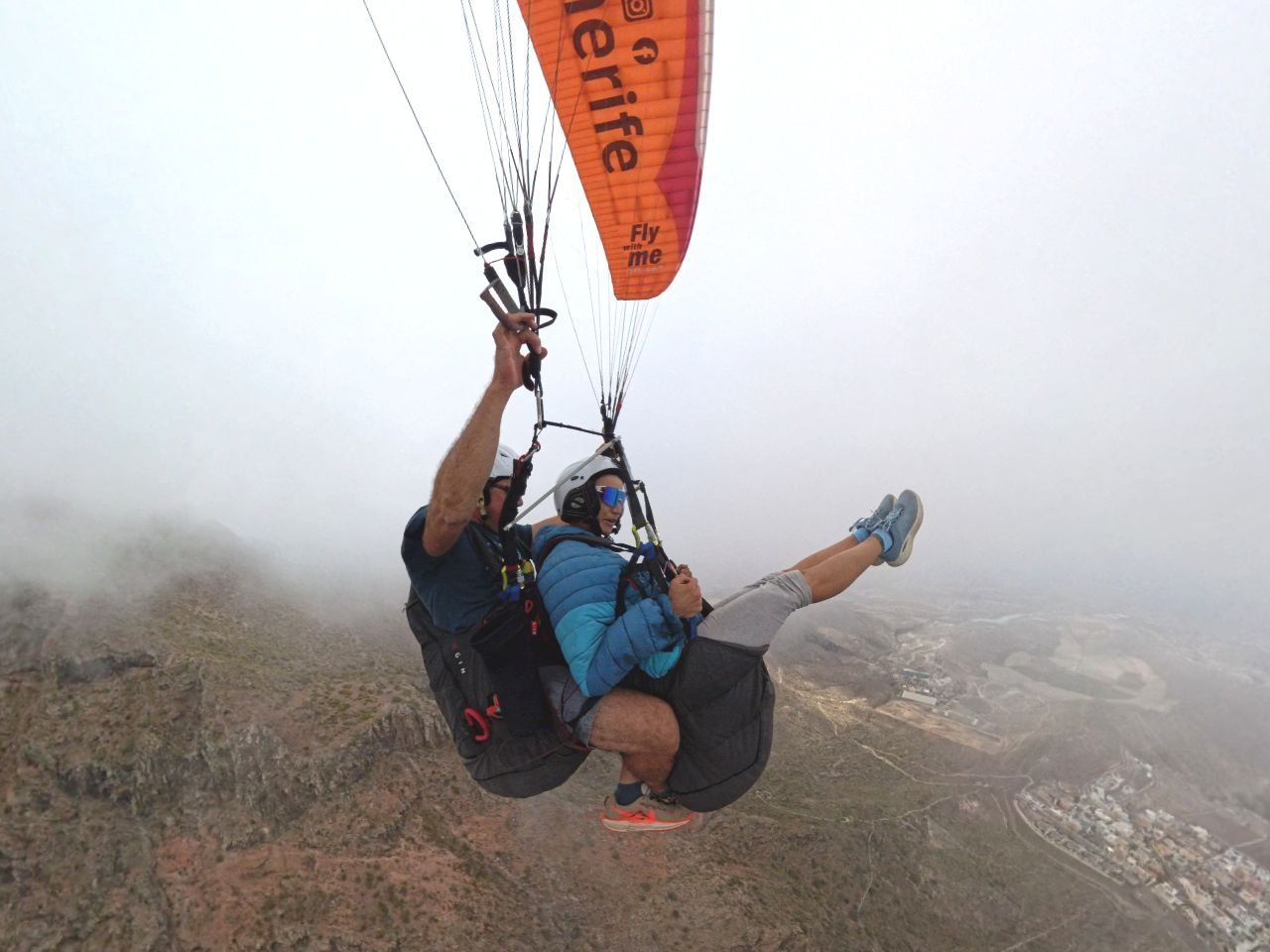 Tandem paraglider flying above the clouds at Taucho, Tenerife